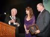 Bennie Fisher, presents Mike & Lori Jones with a IIadro figurine of Don Quixote during the NAA Hall of Fame Induction